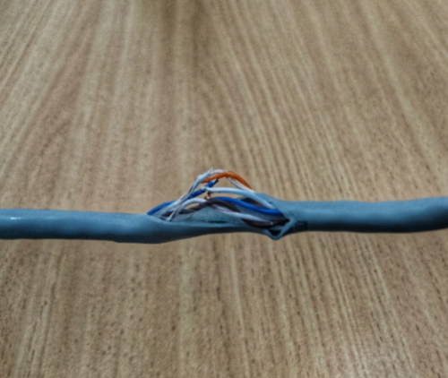 Ask proof before buying electrical products - damaged grey sheathed cable with inner blue white orange wires exposed and torn insulation