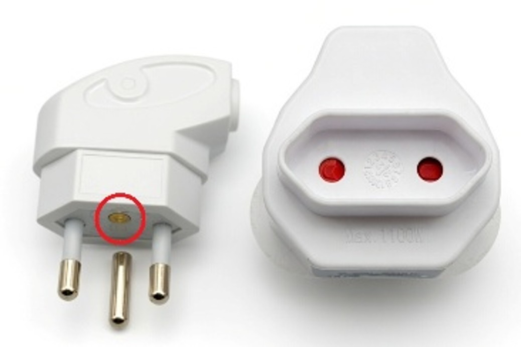 Plug with its earth pin removed and adapter